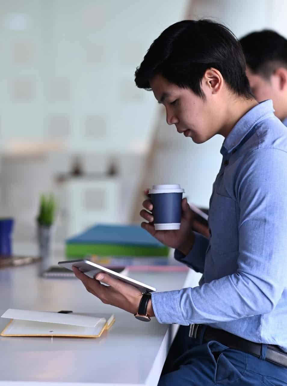 Side view of businessman discussing information and working together in office.