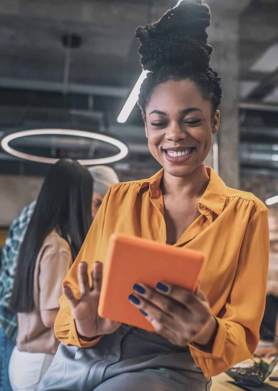 Smiling african american girl with tablet