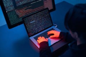 Man using computer and programming to break code. Cyber security threat. Cyber attack