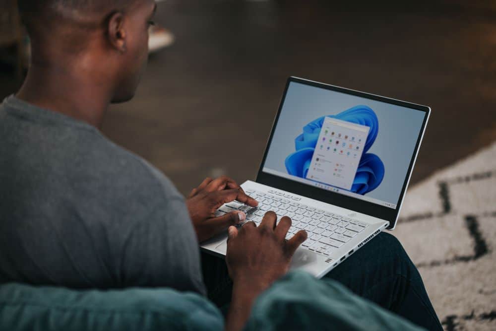Man Using Windows 11 on Laptop