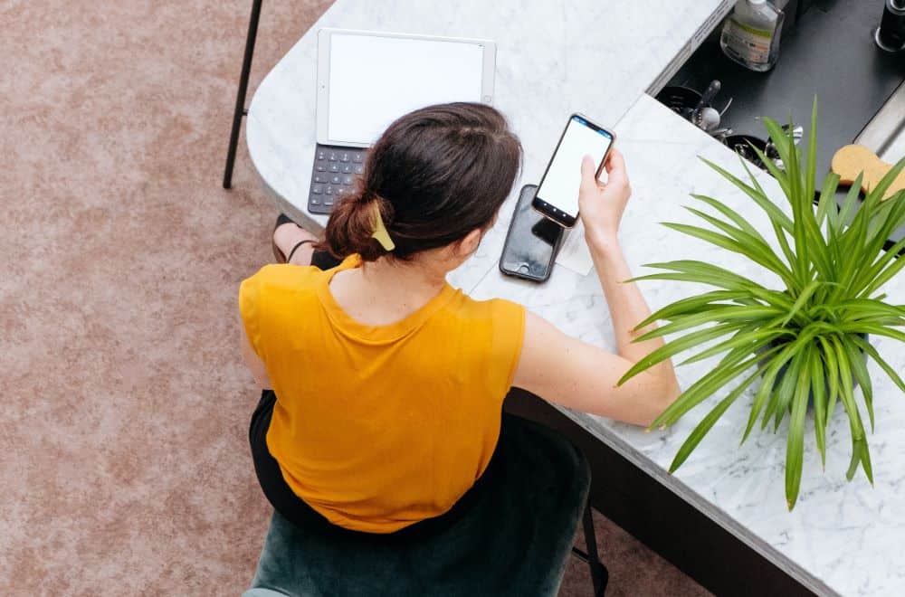 Woman on phone with laptop at desk