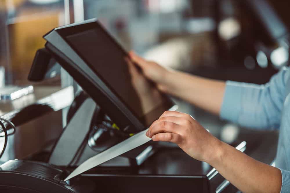 Cashier Using Terminal Device in Business Setting