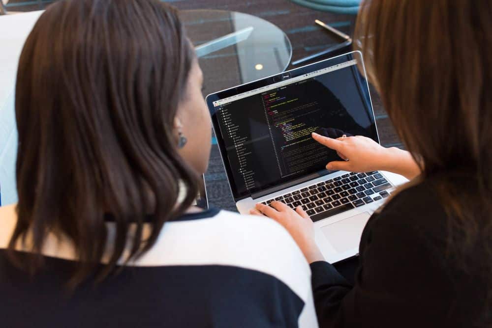 Two Women Looking at Data on a Laptop