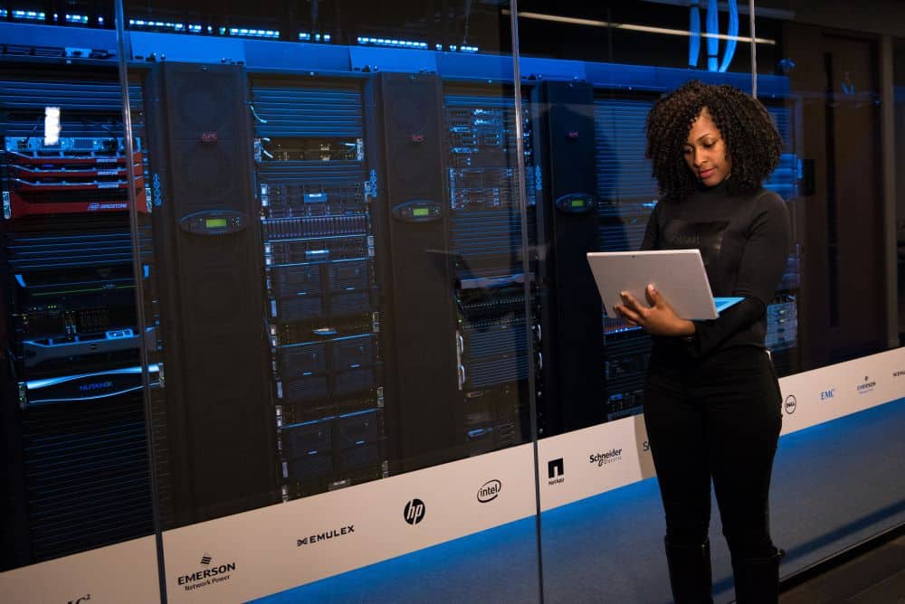 Woman on Laptop Standing Outside a Data Centre