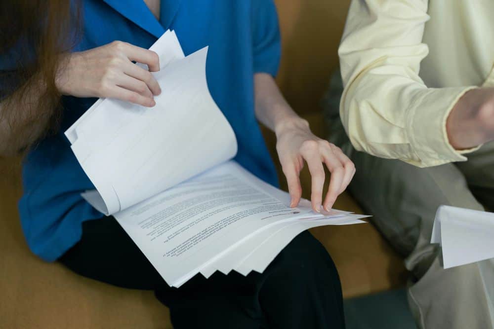 Two People Going Through Information in Files