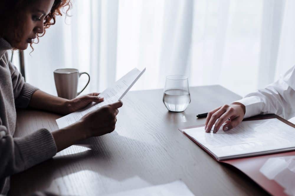 Two People At A Desk Scanning a Contract Document