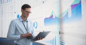 Caucasian,Male,Business,Analyst,With,Laptop,Computer,Standing,Next,To