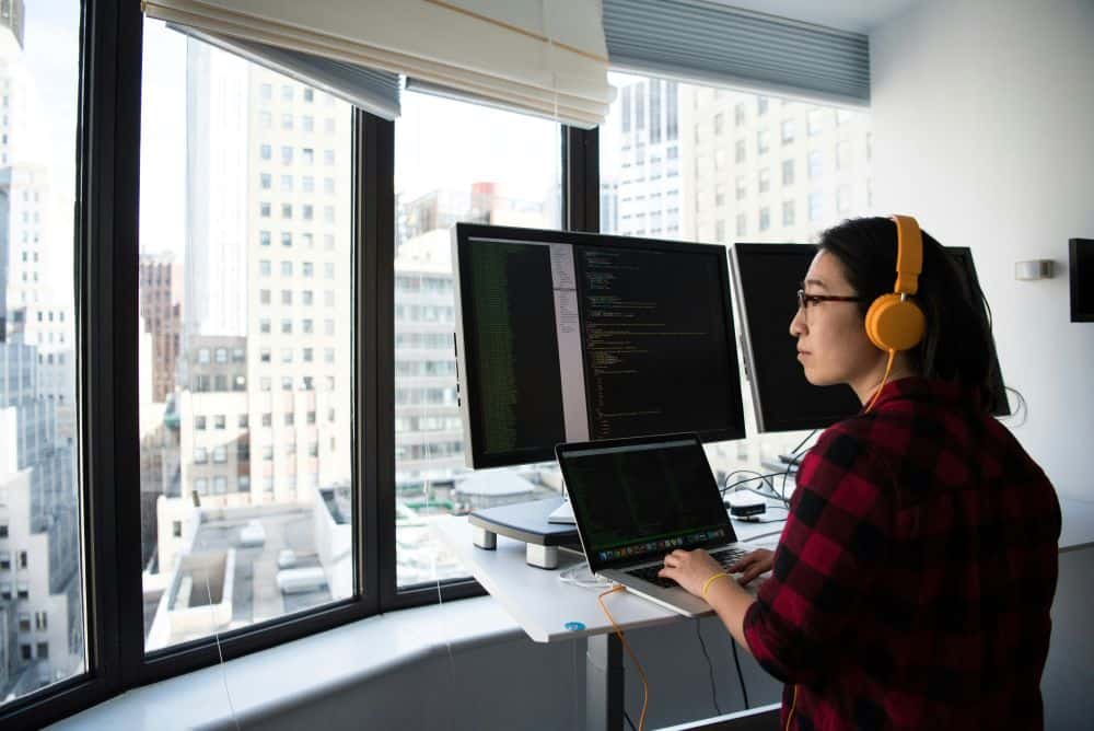 Woman in Office with Multiple Screens
