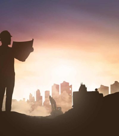 Silhouette of engineer man looking his blueprint in construction sisk group image